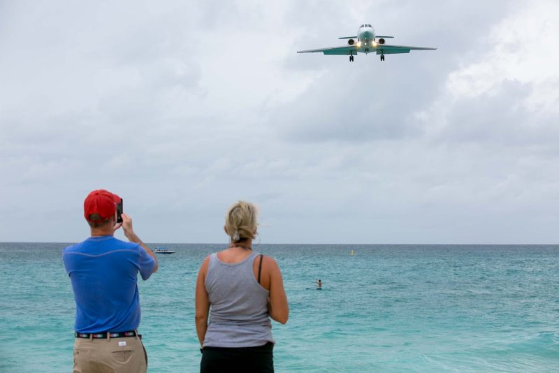 Tourists on Maho Beach watch a plane approach the notoriously short runway on St. Maarten.