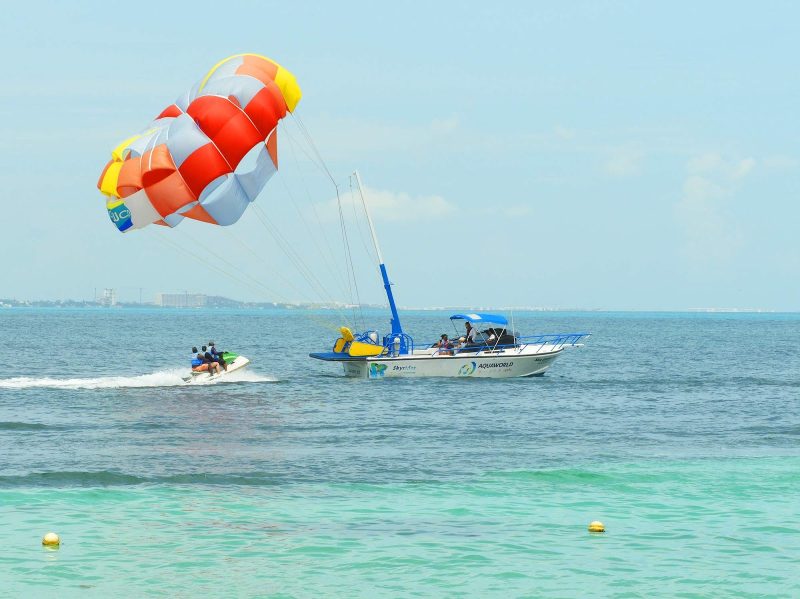 Parasailing, jet skiing and snorkeling are among the water sports available along the beachfront in Cancun, Mexico.