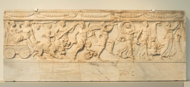 This slab covered a sarcophagus-like grave in a wall, depicting a procession with the Greek god and princess in a panther chariot led by satyrs and maenads, dating to 110-130 A.D. at the Altes Museum in Berlin.