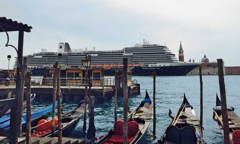 Gondolas bob in the Grand Canal as ms Koningsdam sails through Venice.