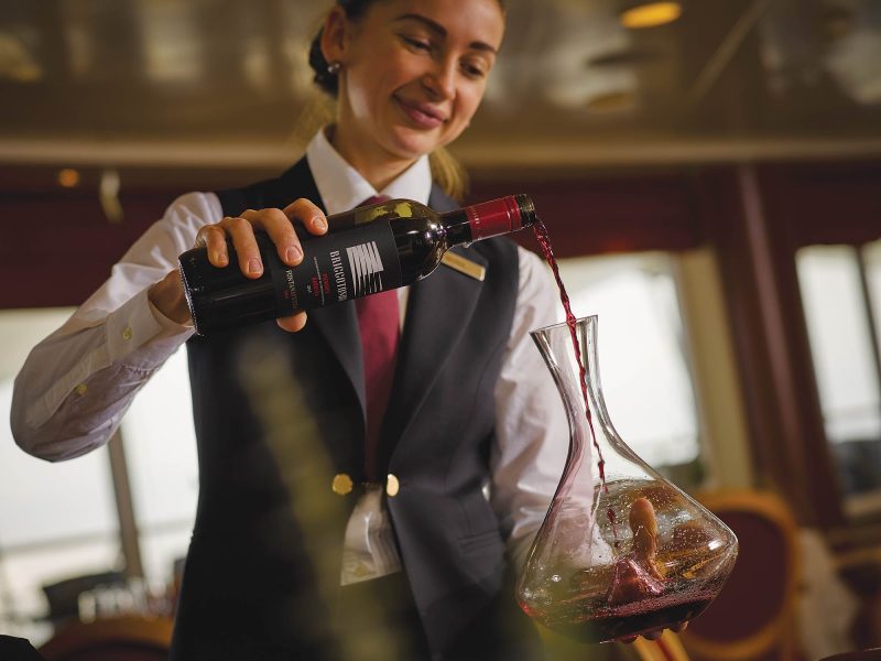 A sommelier decanting wine on a Sliversea voyage.