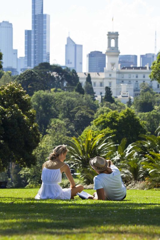 A couple relaxes in Royal Botanic Gardens in Melbourne, Australia. 