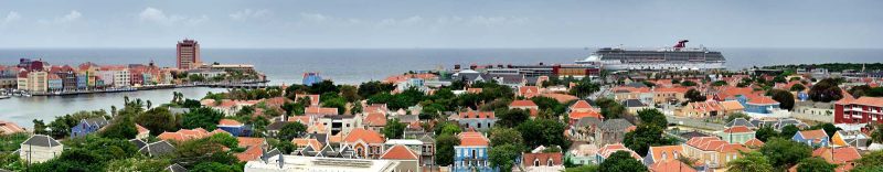 Carnival Breeze sails off the coast of the colorful Caribbean island of Curaçao.