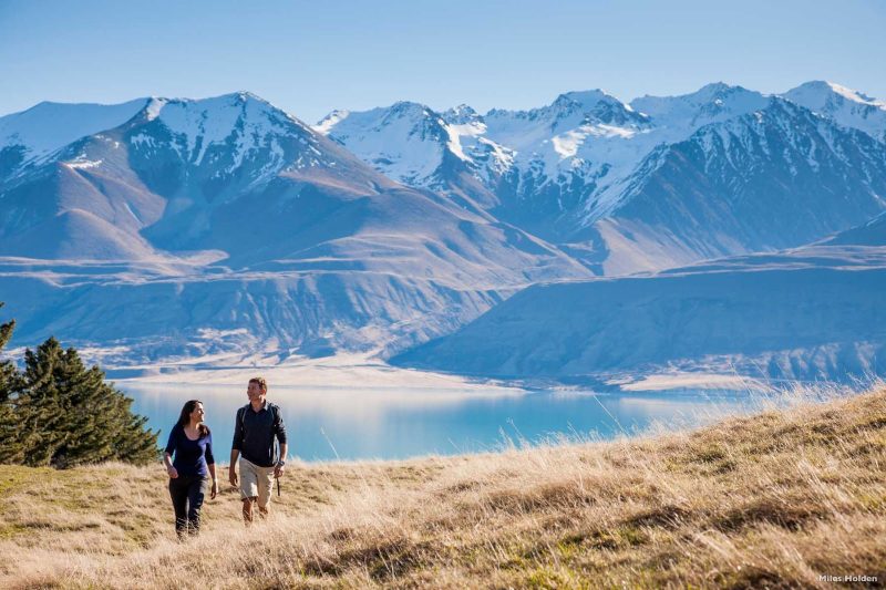 Hooker Valley in the Aoraki/Mount Cook National Park was carved from rock by the relentless creep of glacier ice, leaving dramatic cliffs that rise from the valley floor. Beyond the cliffs, rugged mountain peaks silently carry their mantle of snow.