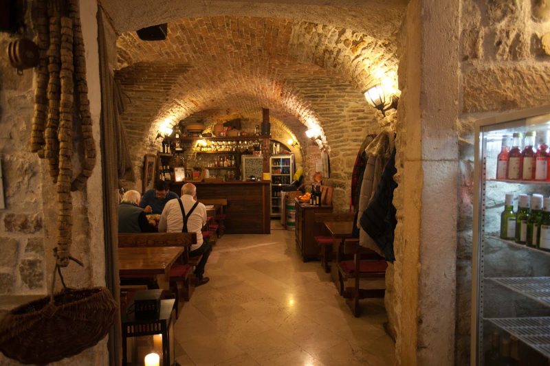 The brick interior of Dalmatinska Konoba Cesarica, a restaurant in Kotor, Montenegro.