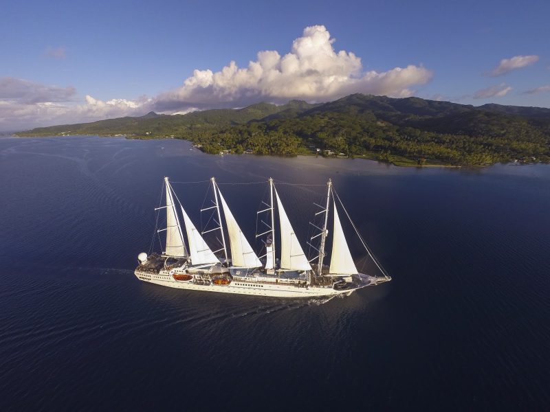 A Windstar sailing yacht cruises past Raiatea