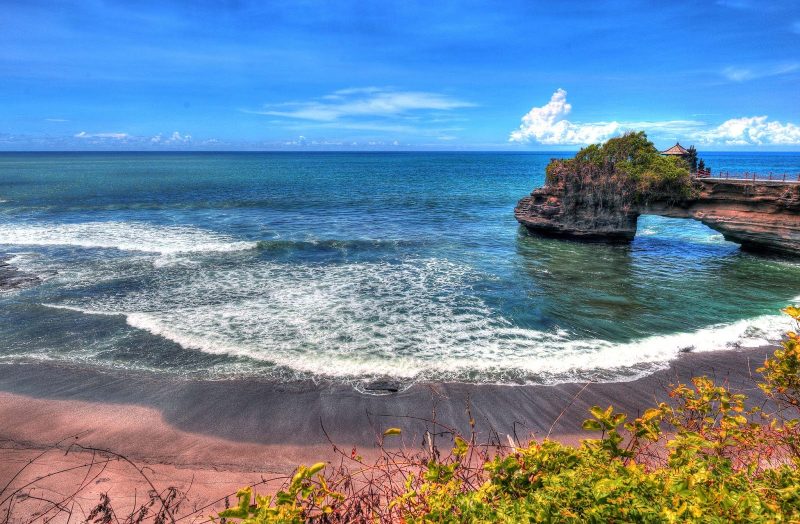 Tanah Lot, a rock formation off the Indonesian island of Bali. It is home to the pilgrimage temple Pura Tanah Lot, a popular cultural icon and photography magnet.