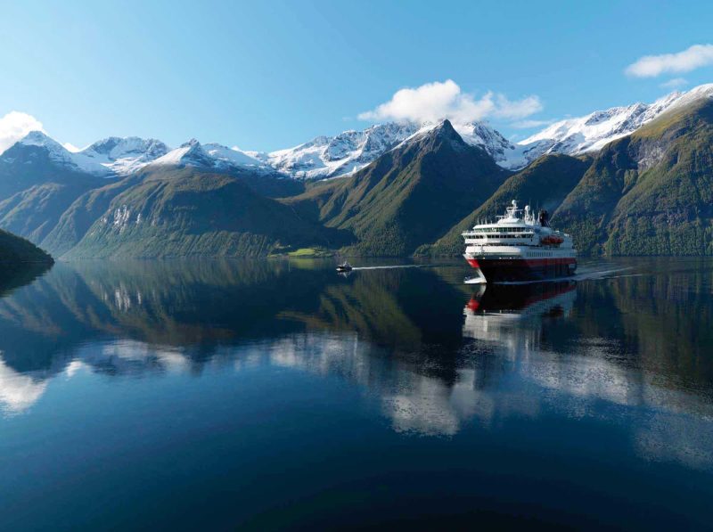 Hurtigruten's Nordnorge sailing during an autumn day along the Hjørundfjorden fjord in Norway.