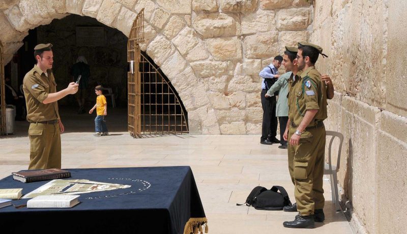 Israeli soldiers pose for photos at the Western Wall in Old Jerusalem.
