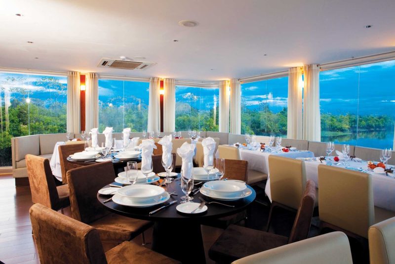 Guests can enjoy the dynamic passing landscapes in the dining room of Aria on an Avalon cruise.