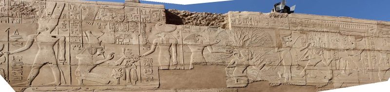 A panorama of a frieze depicting pharoahs and other ancient figures in the precinct of Amun in Karnak Temple at Luxor, Egypt.
