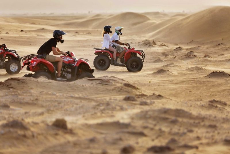 Explore the desert with friends on an ATV during winter in Dubai.