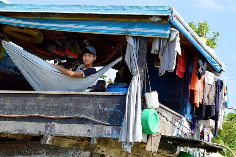 A boy in a hammock is part of life in a floating village on the Mekong River in Vietnam. 