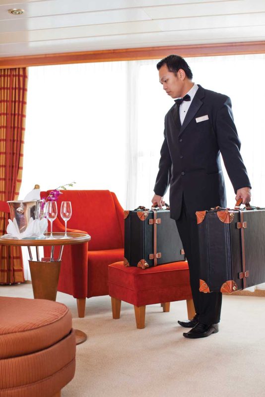 A butler prepares to handle guests' luggage during a Regent Seven Seas voyage.