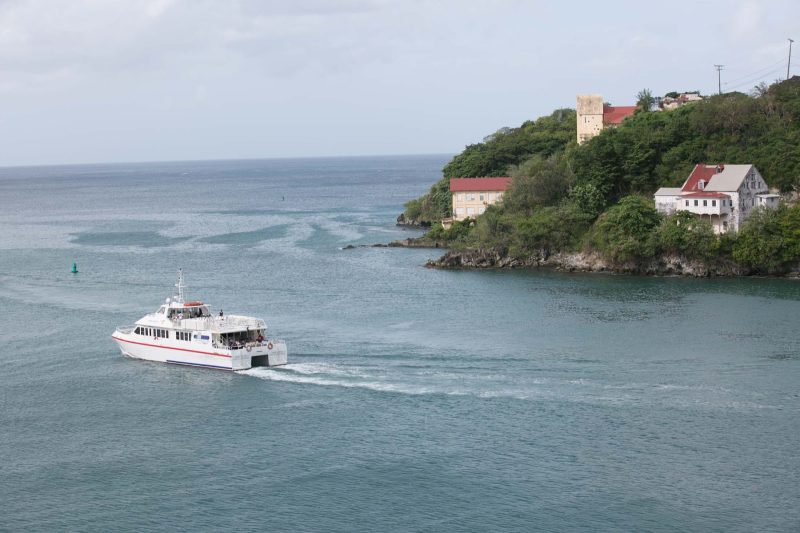 A pleasure boat exits the harbor of St. George's, Grenada, on a fall morning.