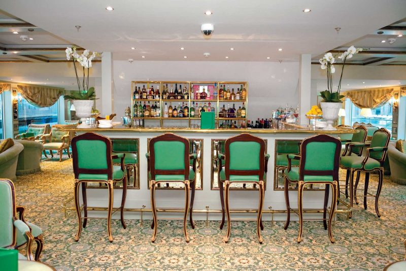 Settle in with a drink at the bar of the Salon du Grand Trianon as you travel along the Rhine River aboard the S.S. Antoinette.