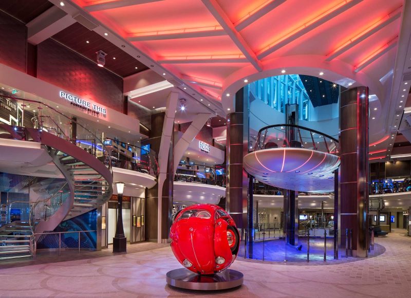 The Rising Tides Bar on Symphony of the Seas serves as a slow-moving elevator connecting the Royal Promenade and Central Park.