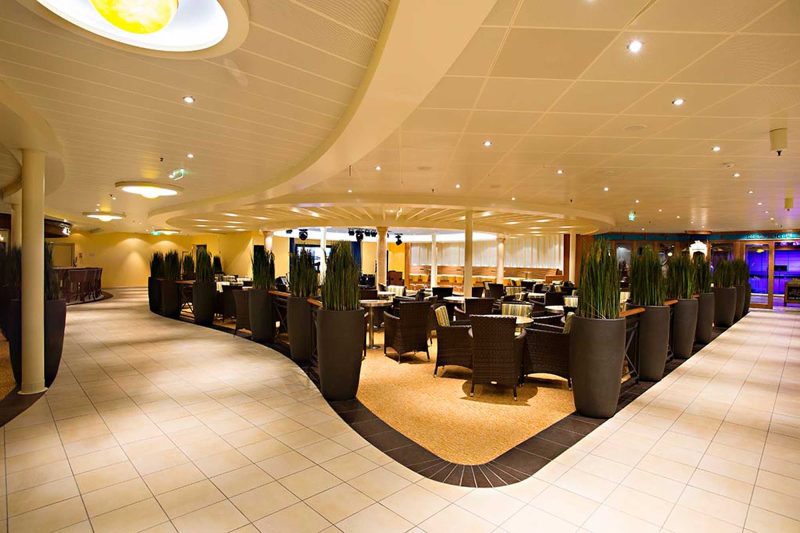Dance the night away with the sea as your backdrop in the Ocean Plaza aboard Carnival Sunshine.
