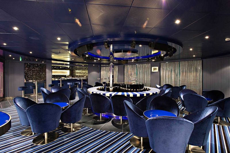 Relax with a cocktail and listen to pop favorites at Piano Bar 88 aboard Carnival Sunshine.