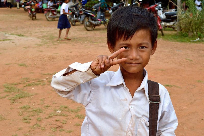  A young boy flashes a V sign, a common gesture for greeting strangers, in Vietnam. 