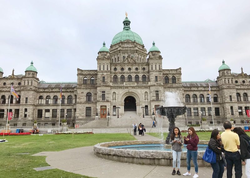 Visitors take in the Capitol Building of Victoria, British Columbia.
