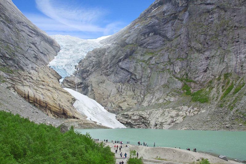 Visitors to Jostedalsbreen National Park walk from the glacial lake to the Jostedalsbreen north of Bergen, Norway.