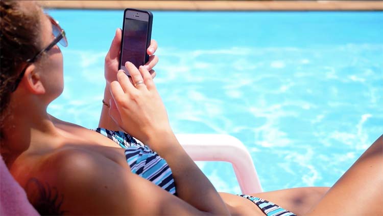When using your smartphone at poolside, choose a cruise ship plan that doesn't run up your bill.