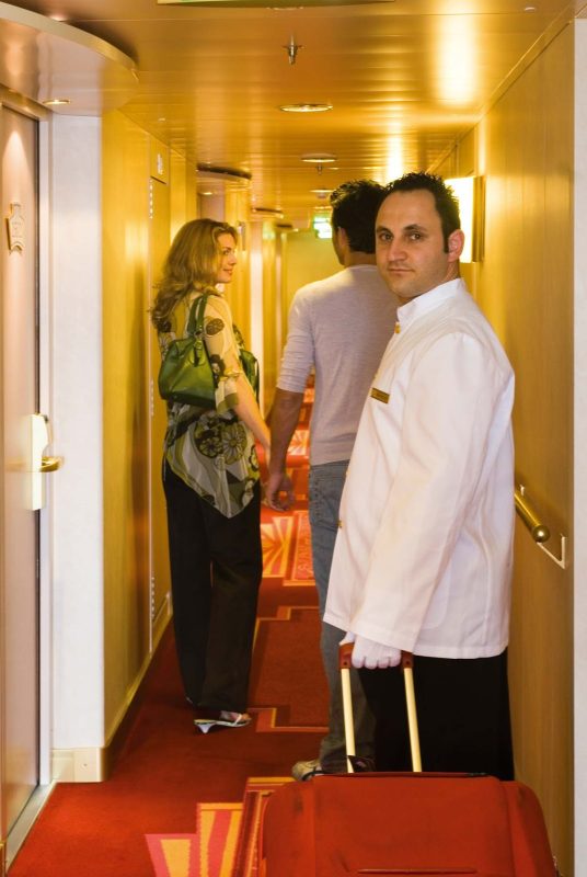 A butler assists a couple with their luggage during a sailing on MSC Cruises.