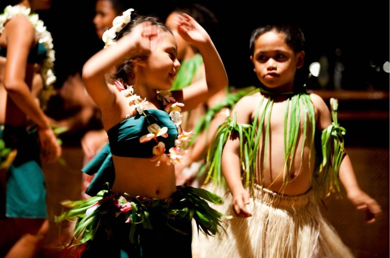 Children dancing in traditional garb in the Cook Islands.