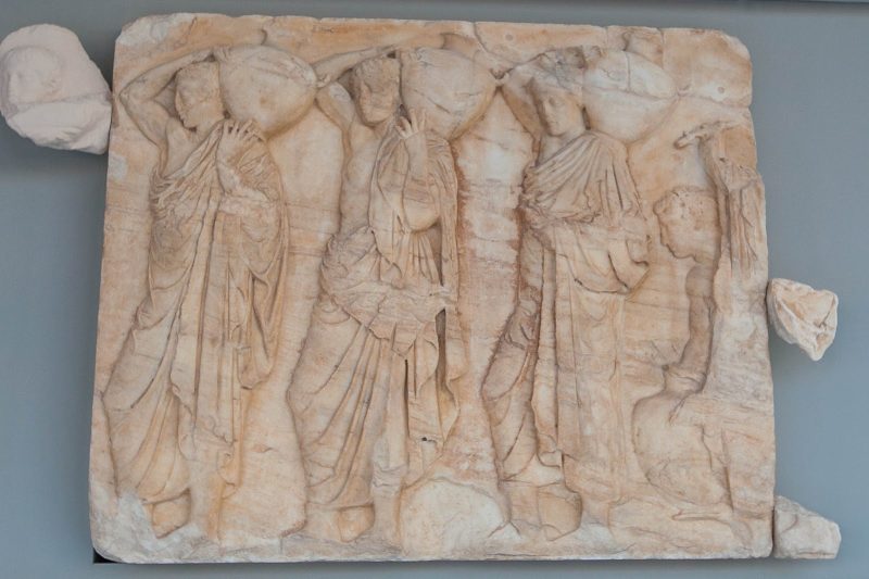 A relief depicting people carrying amphoras (water containers) at the Acropolis Museum in Athens. 