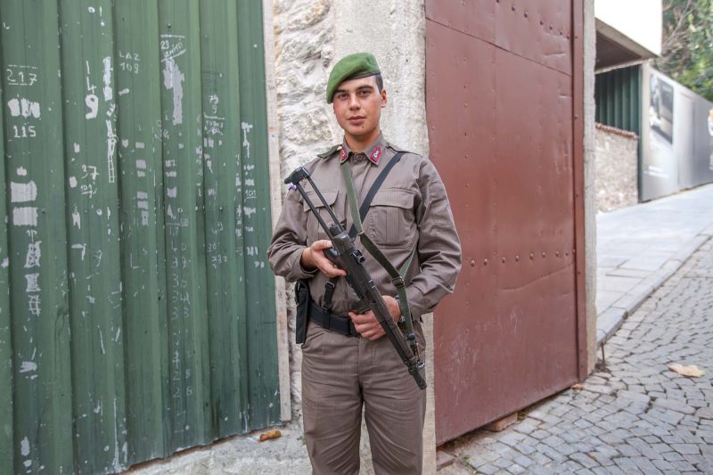 A Turkish soldier, with green beret and submachine gun, stationed near the entrance of a tourist attraction in Istanbul.
