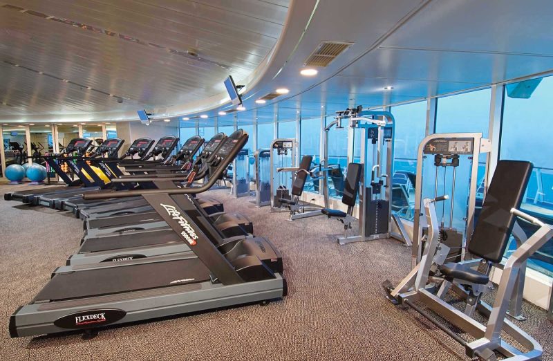 Work up a sweat with a view of the sea at Enchantment of the Seas' ShipShape Fitness Center.