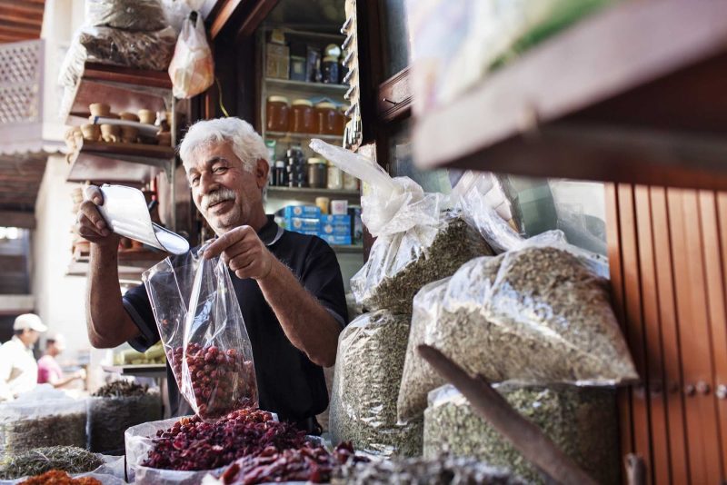 A local vendor measures some produce at the Spice Souk (market) in eastern Dubai.