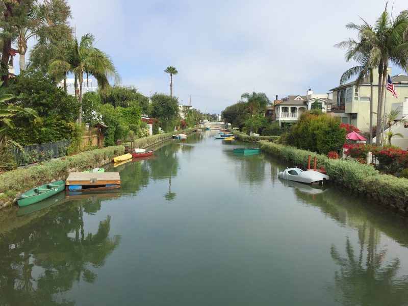 A view from a footbridge spanning one of the canals of Venice, California.
