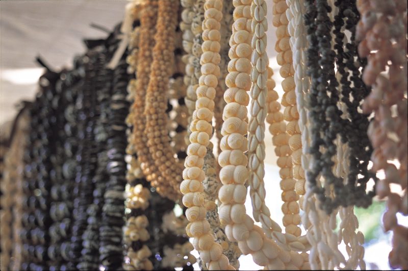 Near the entrance on the Waikiki Beach side, a sundry market is set up every Sunday at Kapiolani Park on Oahu. Lei made from shells and nuts are a popular item.