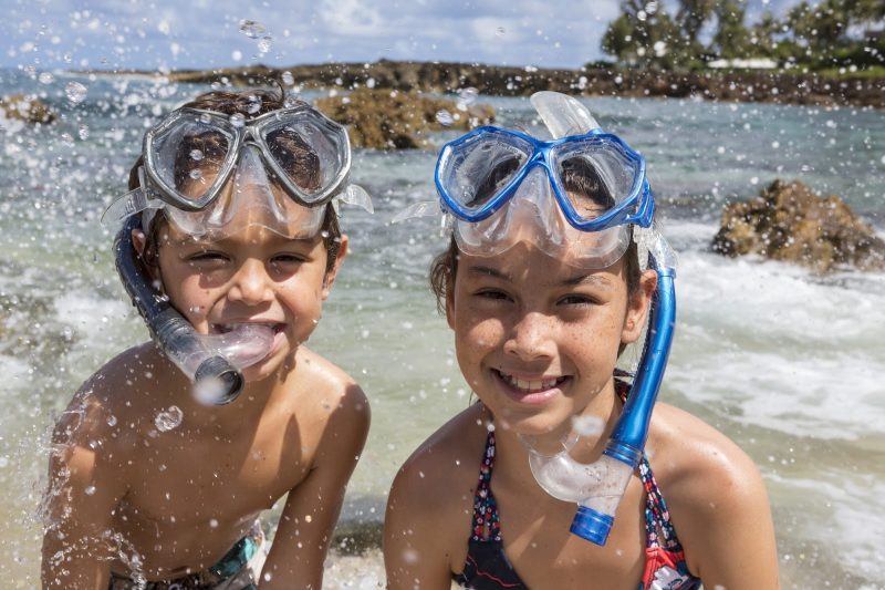 Kids get ready to snorkel on the north shore of Oahu.