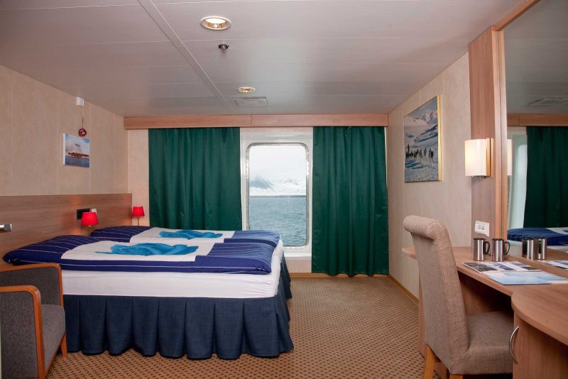The Cabin 4 Stateroom aboard Expedition from G Adventures has two twin beds that convert to a king-size bed and a large window for watching the passing landscapes.