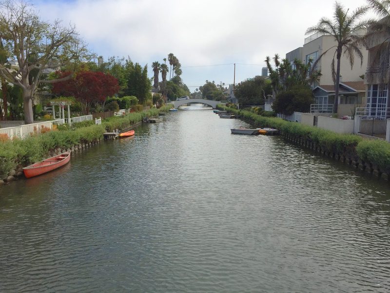 A view from a footbridge spanning one of the canals of Venice, California.