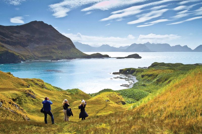 Guests from a Lindblad Expedition ship hike step into a landscape painting in South Georgia.