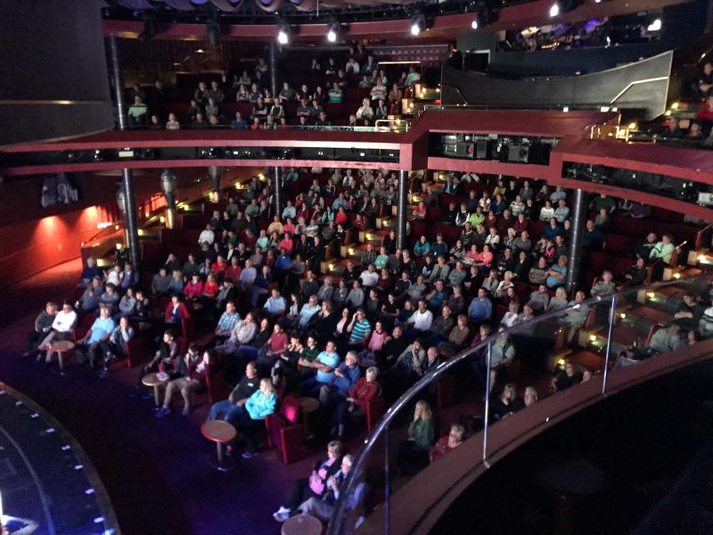 Theatergoers enjoying a BBC Earth production during a sailing on ms Oosterdam.