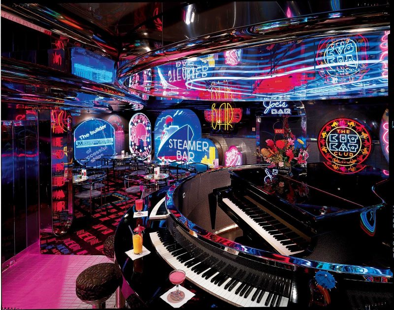 Enjoy a cocktail and sing along with the crowd at Carnival Ecstasy's Neon Piano Bar.