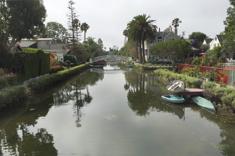 A view from a footbridge spanning one of the canals of Venice, California.