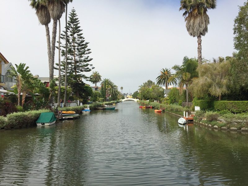 A view from a footbridge spanning one of the canals of Venice, California.