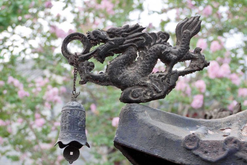 Incense burner dragon with bell in the White Cloud Temple in Beijing. 