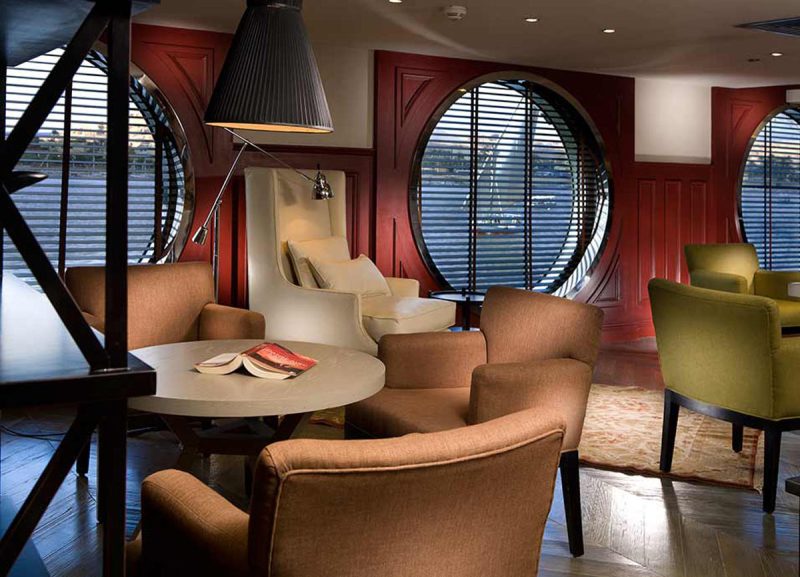 Curl up in a quiet setting at the Upper Mezzanine library aboard ms Mayfair.