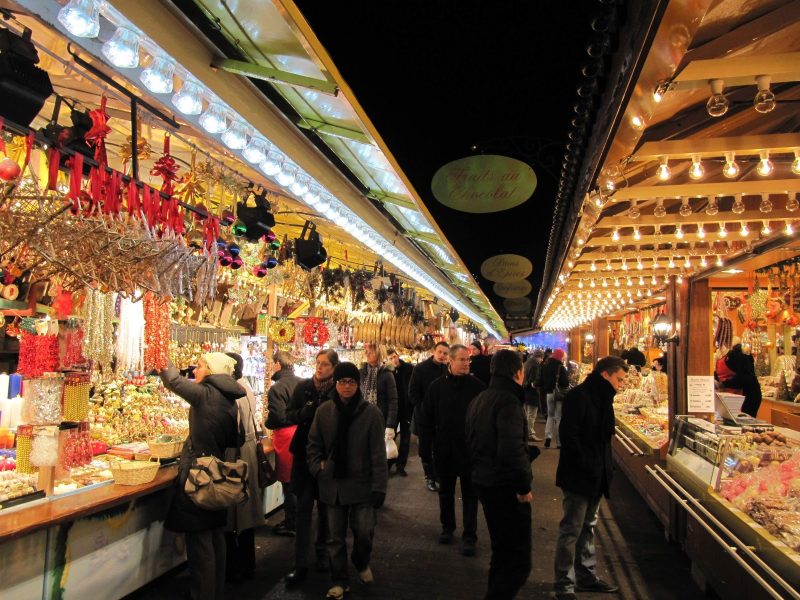 People shop for decorative knick knacks and keepsakes in a Christmas market in Strasbourg, France.