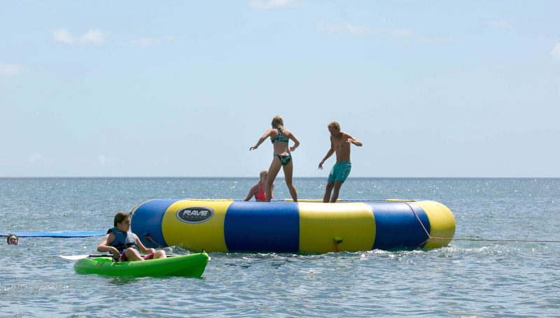 Passengers relax on a giant ocean float at the rear of Wind Surf.