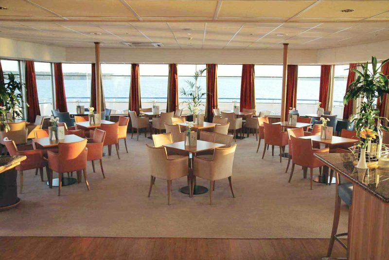 Relax and enjoy an afternoon aperitif while taking in the scenery in the Panorama Bar on board your Viking Cruises ship during your vacation in Russia.