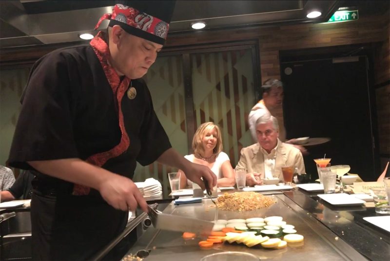 A teppanyaki chef prepares a meal aboard Norwegian Jade.