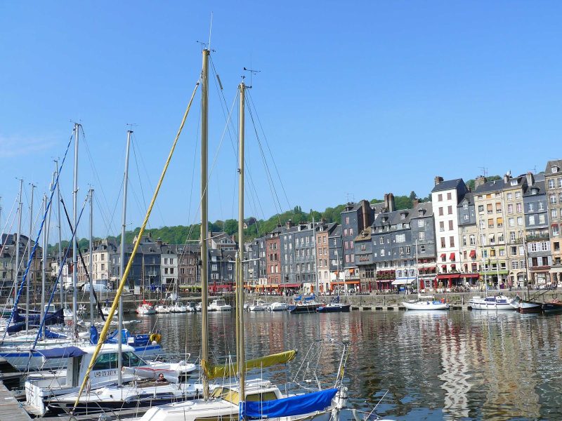 Packed with cultural sights, Honfleur harbor is located in an estuary where the Seine meets the English Channel.